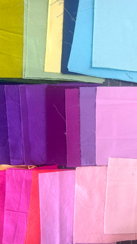 square pieces of cotton fabrics in a rainbow of colors