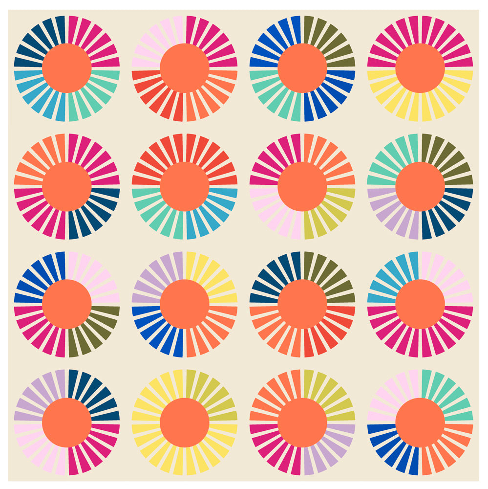 A colorful quilt made of quarter circle wedges on pale cream background.