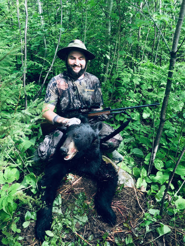 Jordan Beauchamp proudly posing with his successful bear hunt.