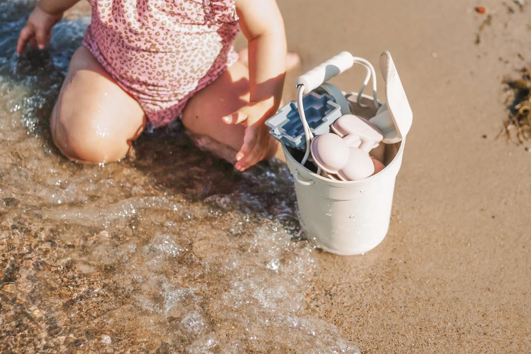  baby/toddler playing with beach toy set