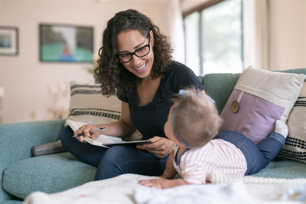 A mother is writing in a journal