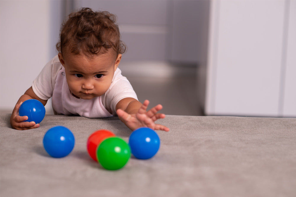 Baby playing with plastic balls