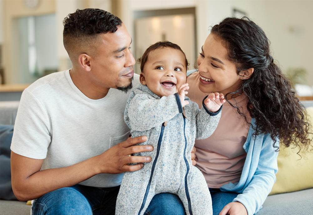 A young family bonding with their baby boy at home