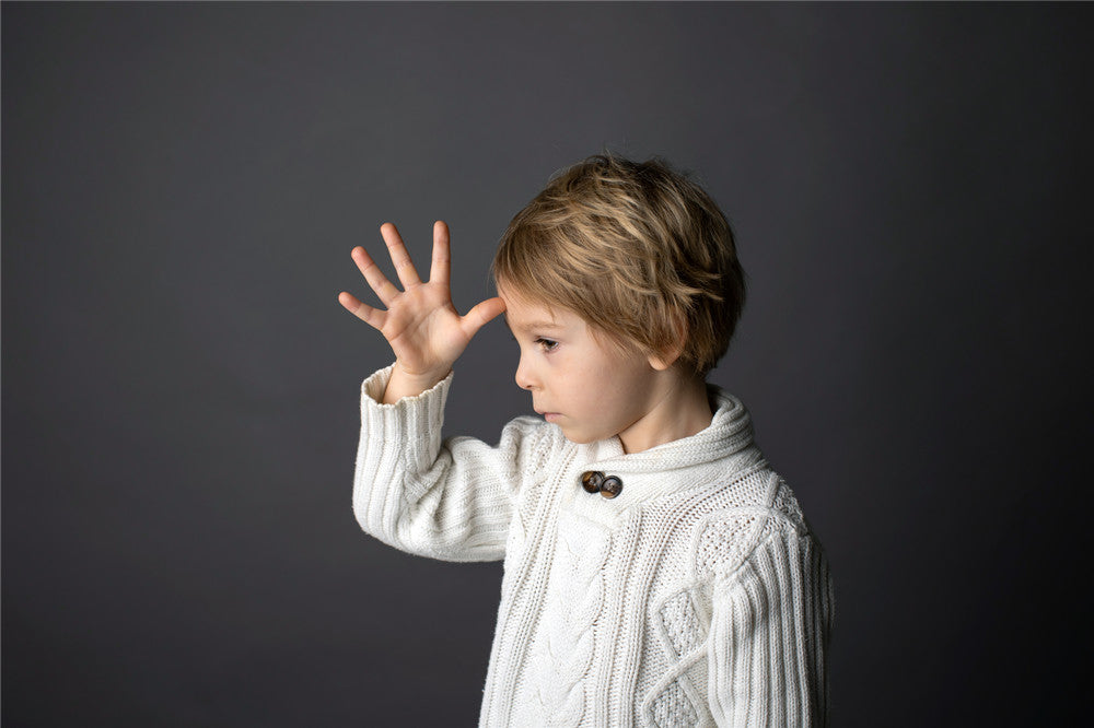 Cute little toddler boy, showing FATHER gesture in sign language