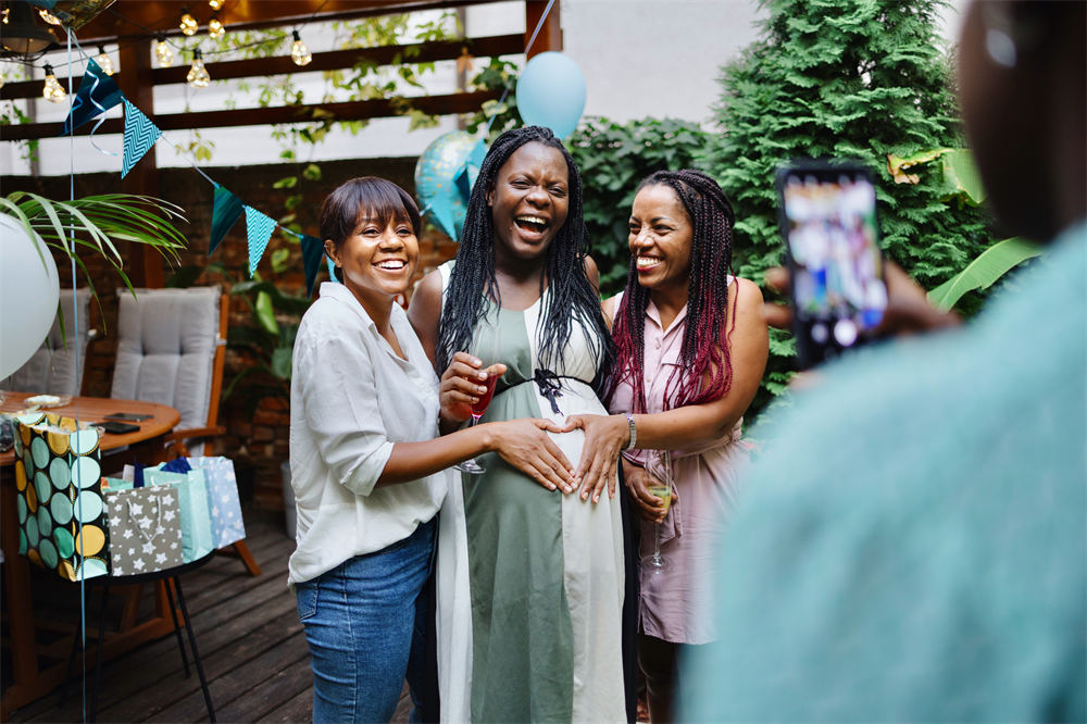 Group of women taking photos during a baby shower