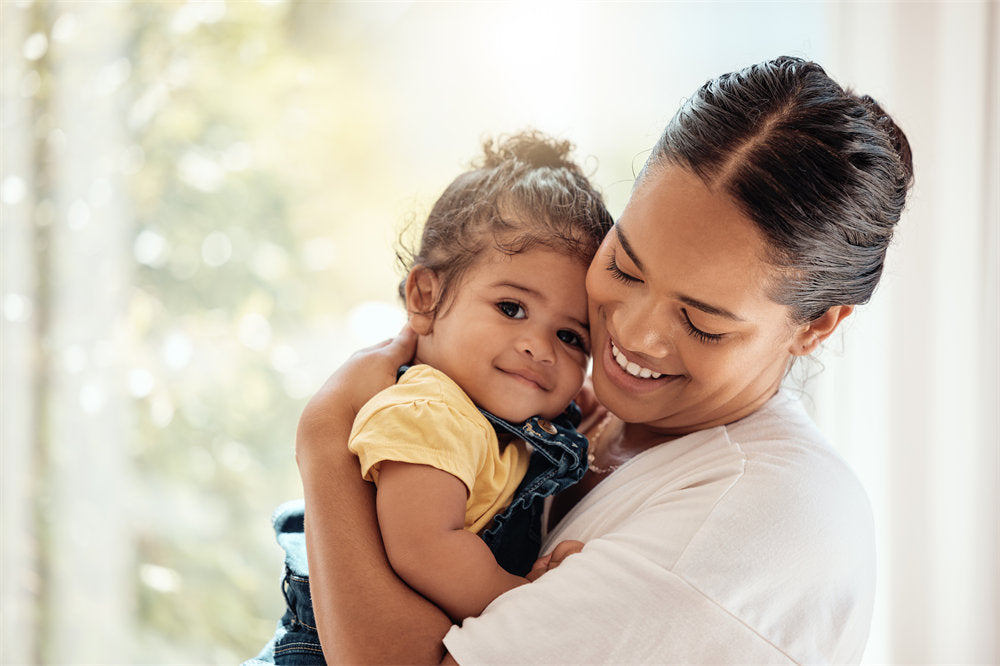 Woman carrying child for security and safety in their family home