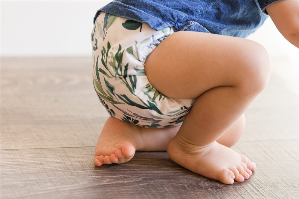 A 1-Year-Old Baby Boy Playing on the Floor & Learning to Walk While Wearing Just a Cloth Diaper