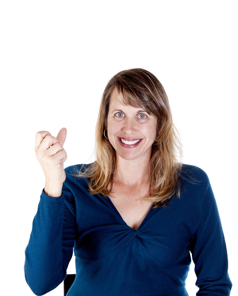 Smiling Caucasian woman making the ASL hand shape for MILK