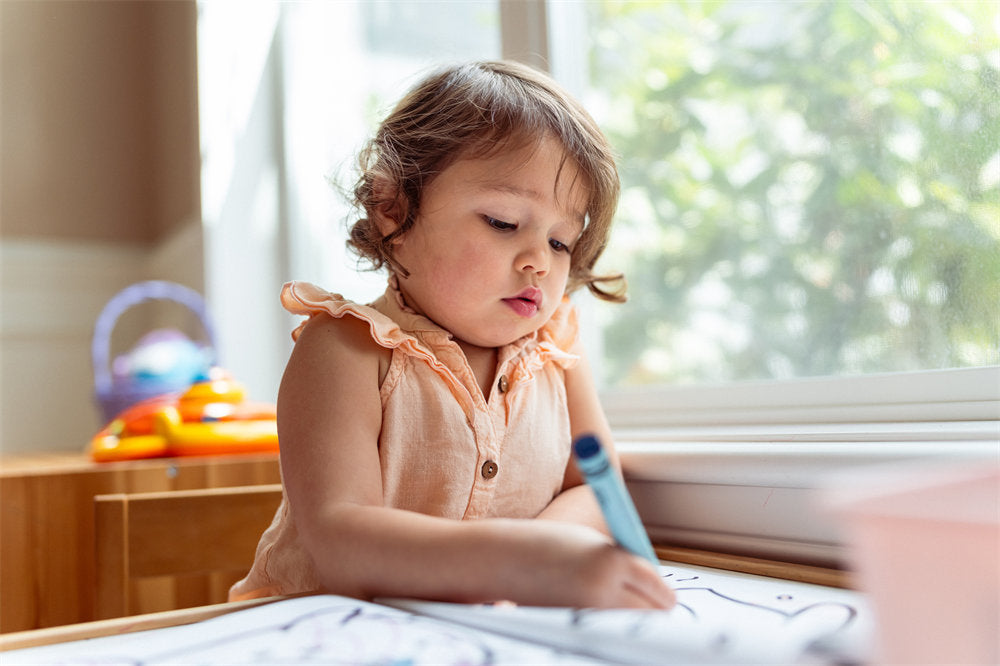 Multiracial preschool age girl coloring in a coloring book