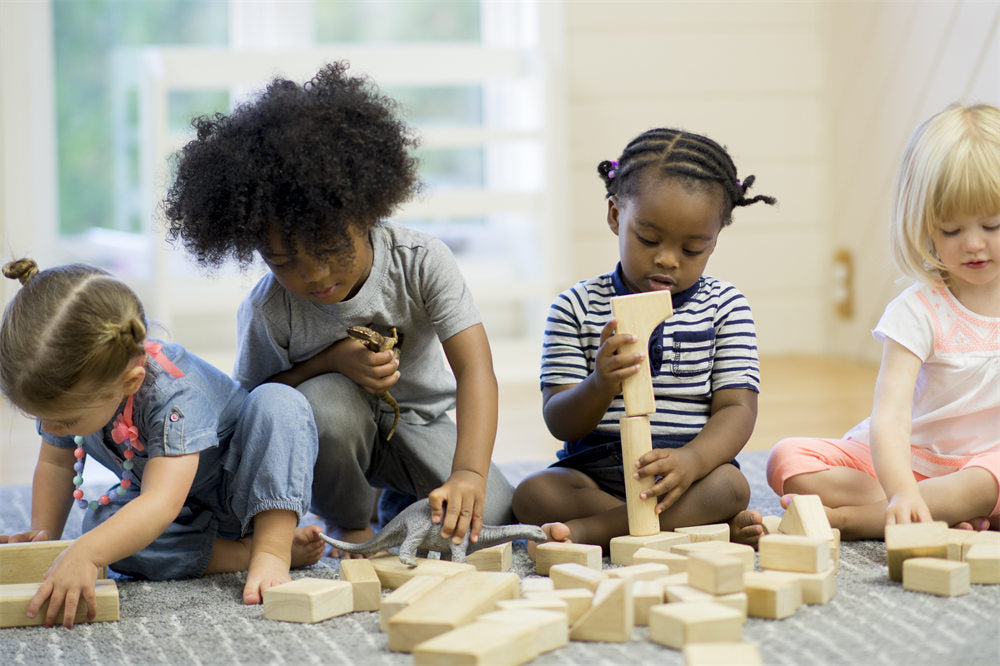 A group of toddlers are playing with toys together in preschool