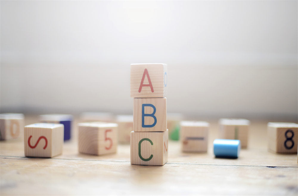 Toy building blocks stacked to spell out ABC