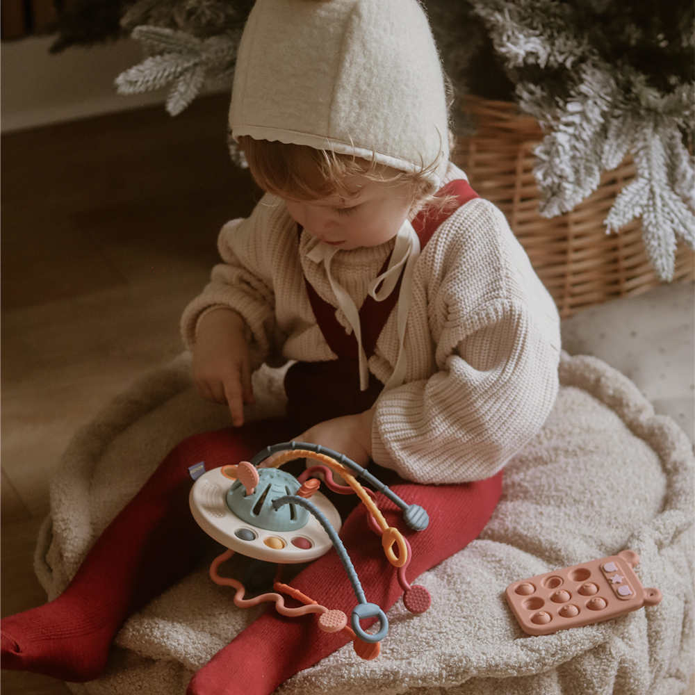 Baby playing with Moonkie silicone baby toy