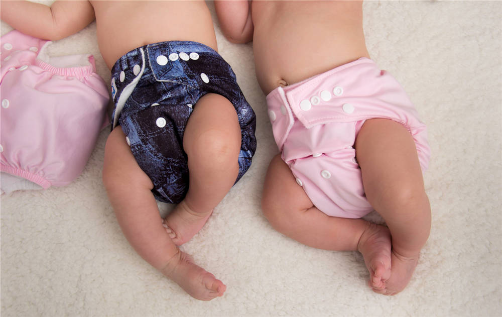 Baby lying down wearing cloth diaper