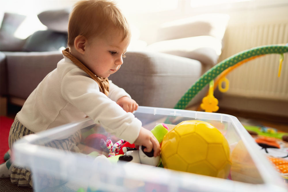 baby boy choosing the toy