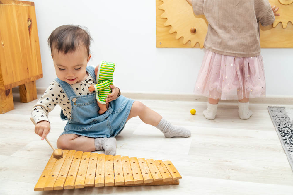 Toddler playing xylophone