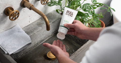 Face Wash squeezed into mans hand over sink