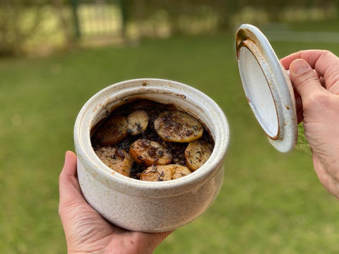 Woman Holding Handmade Ceramic Pot with Beef & Potato