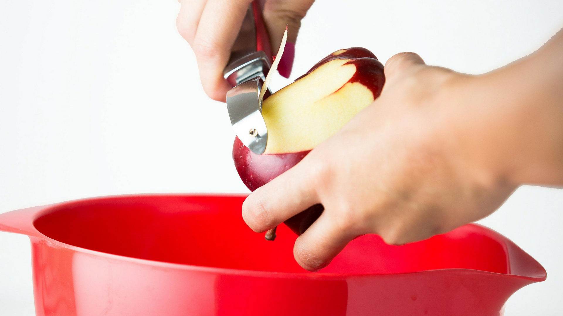 Peeling a red apple