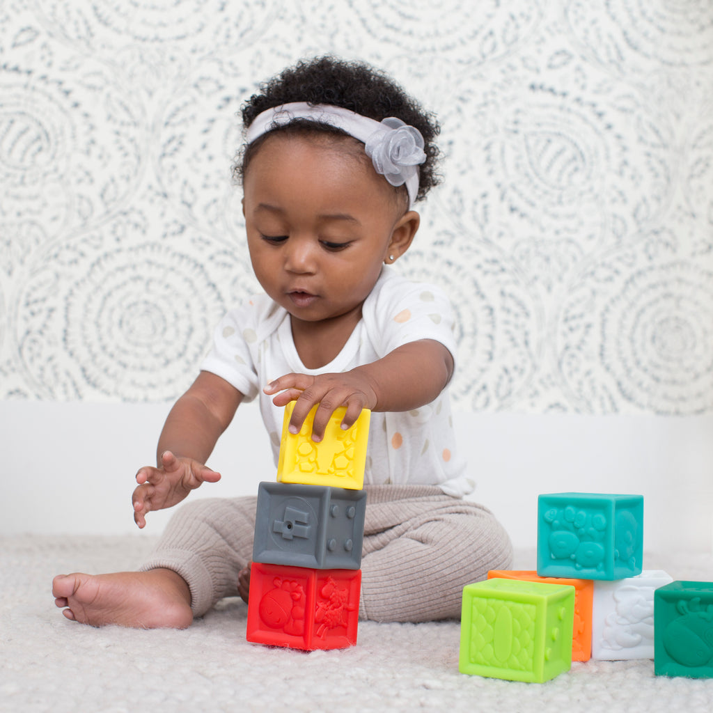 babies stacking blocks