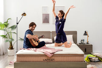 happy couple is happily jamming together on top of their lazycat mattress mocha