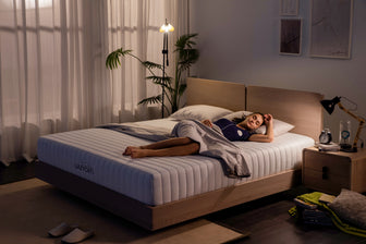 woman sleeps peacefully on her lazycat foam mattress cream