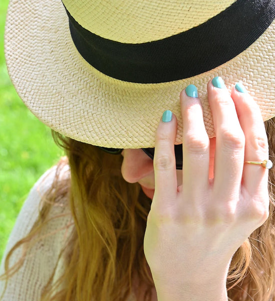 Woman with sunhat and nail polish