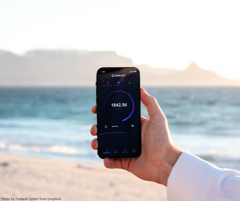 A man checking the wifi signal at a beach spot