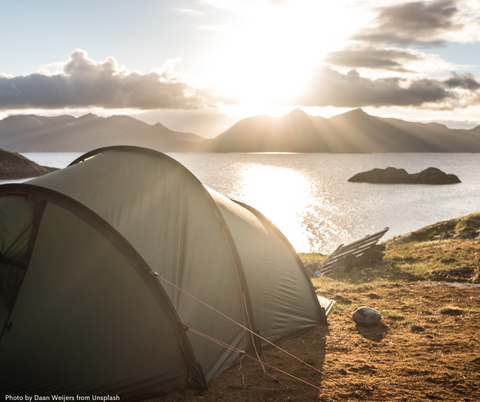 Tent spot with a view over a lake and mountains