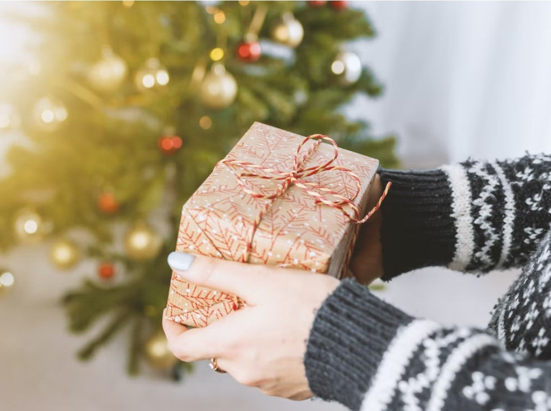 hand of the person holding the gifts box