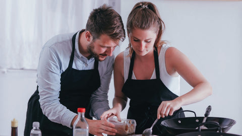 A couple taking a cooking class