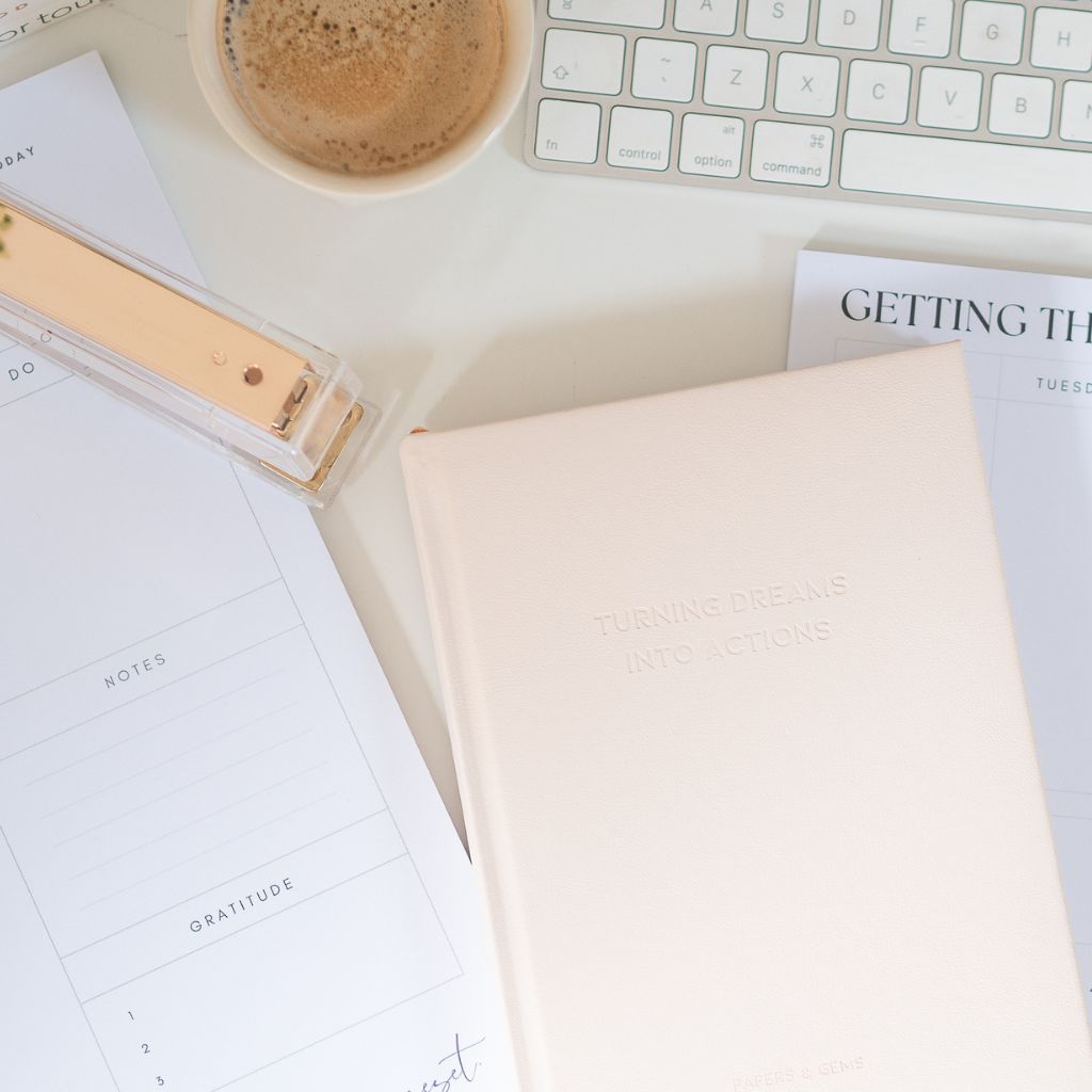 A5 taupe pink notebook and planner on desk