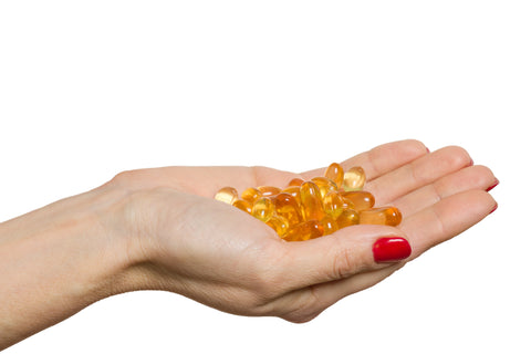 Omega 3 supplements in hand