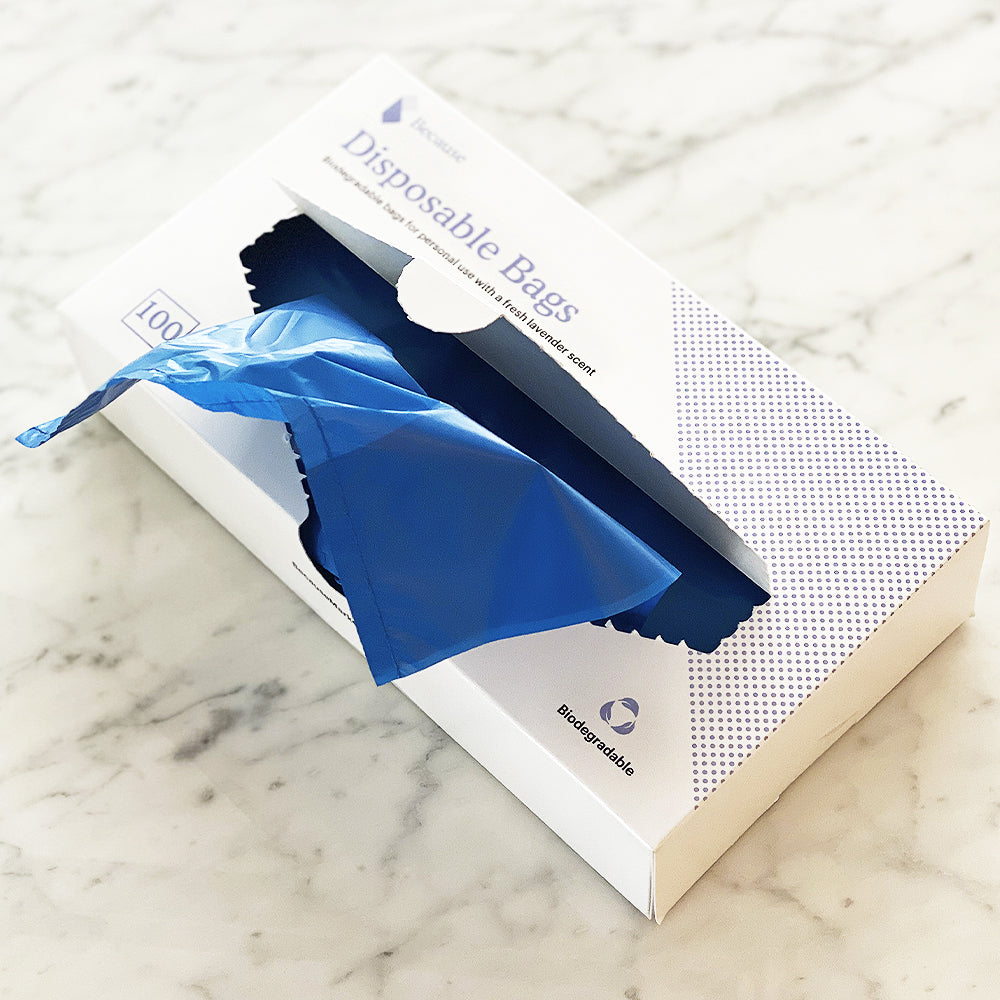 Blue incontinence bag sticking out from its packaging