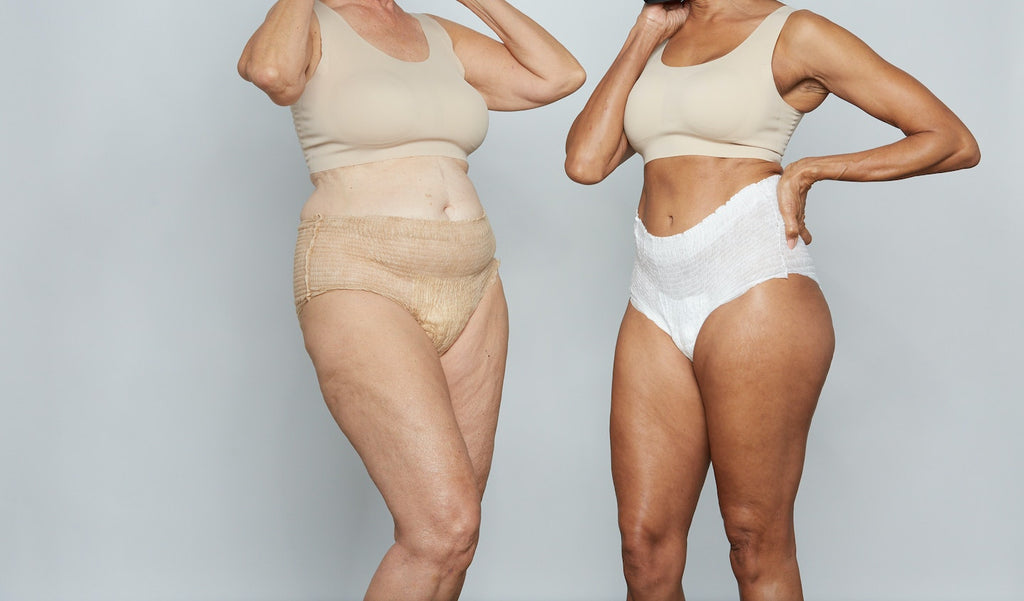 Two women stand in Because Market incontinence underwear.