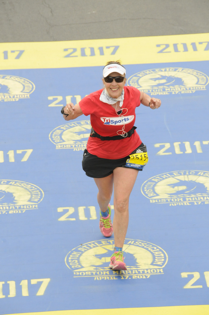 Ellen Demsky celebrates as she crosses the finish line.