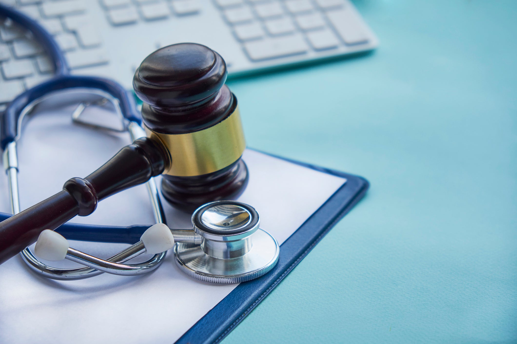 A gavel, patient chart, and stethoscope.