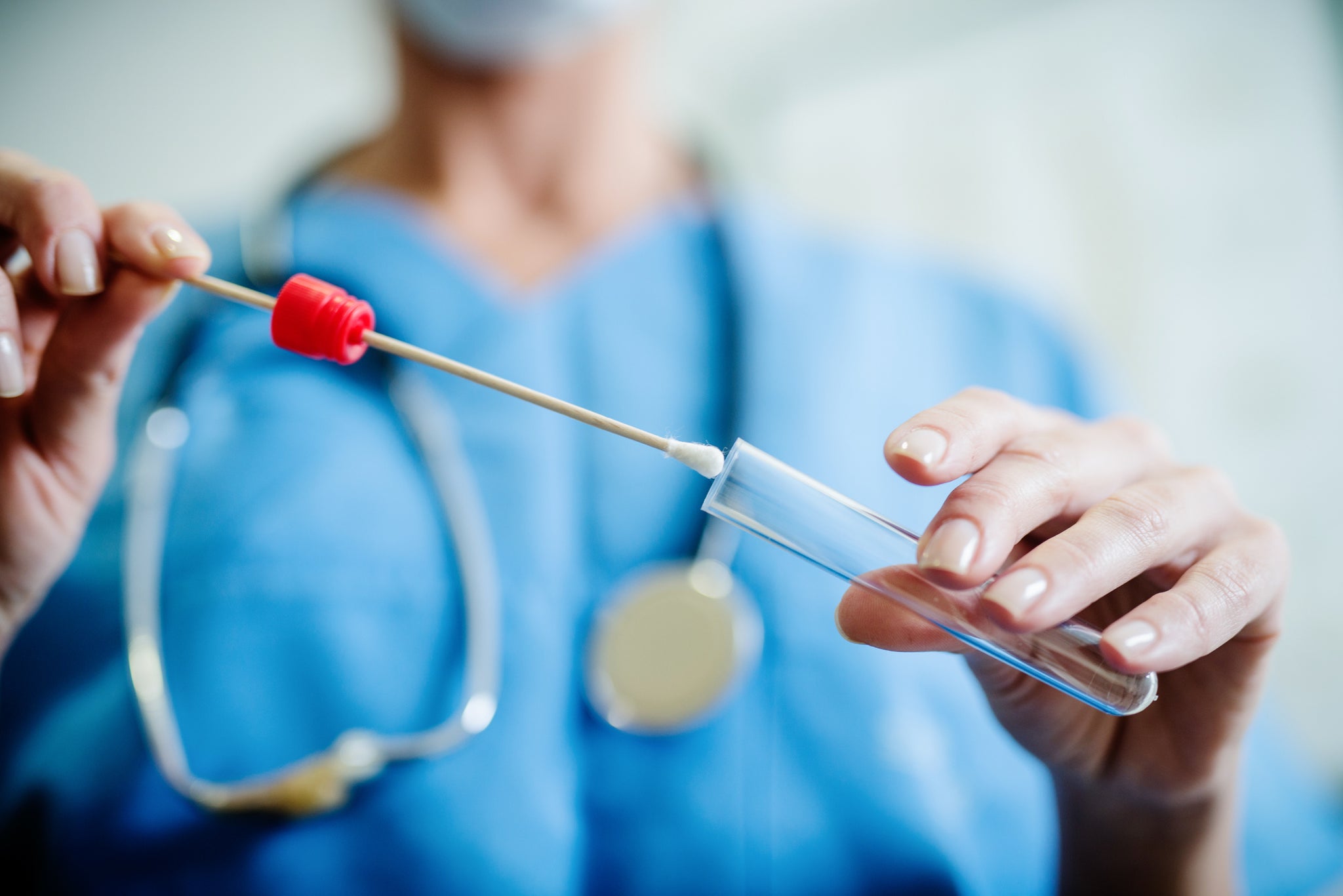 A doctor collects a swab.