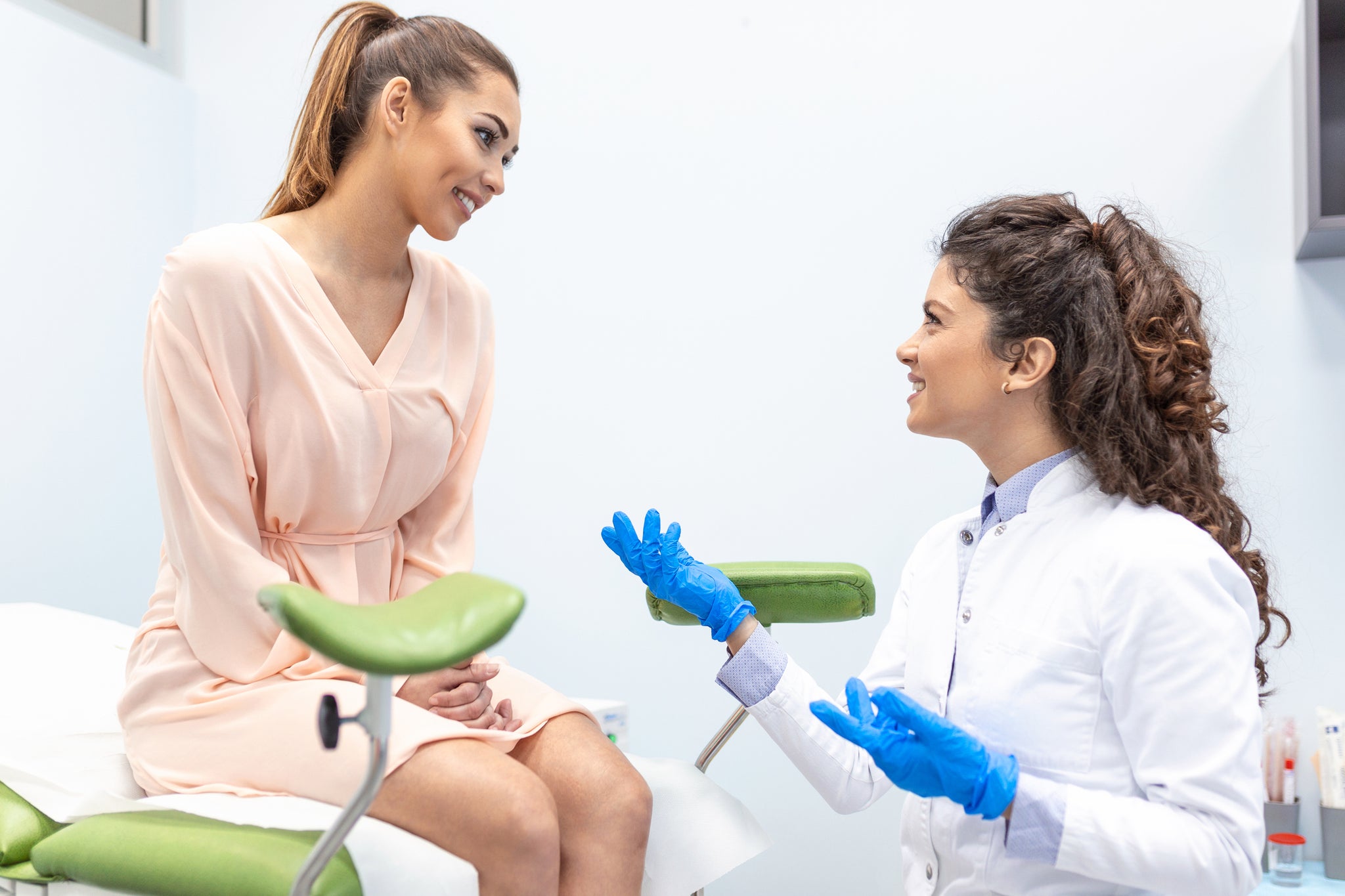 A woman prepares for a pelvic exam