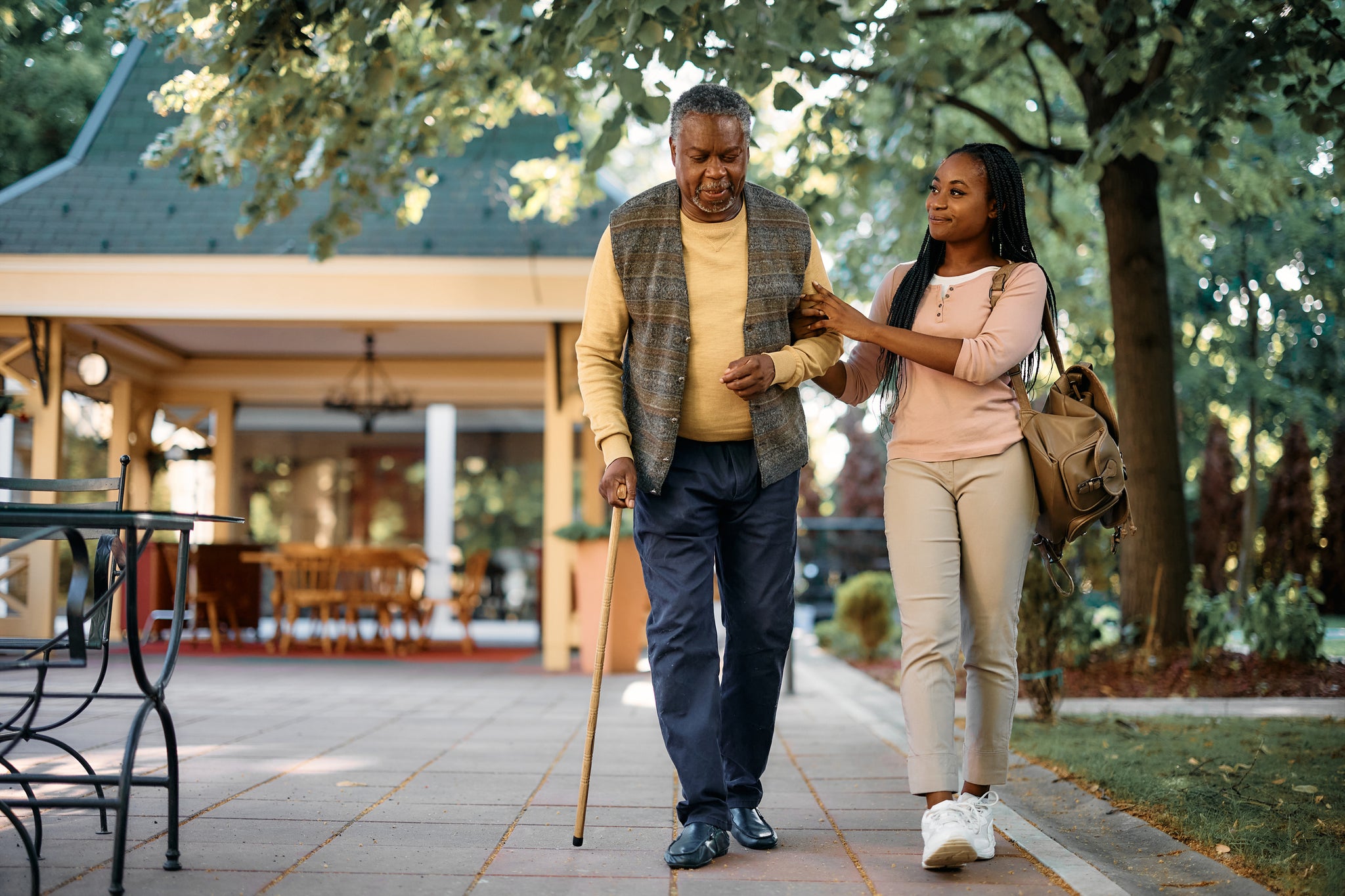 A man and a young woman walk in a public area.