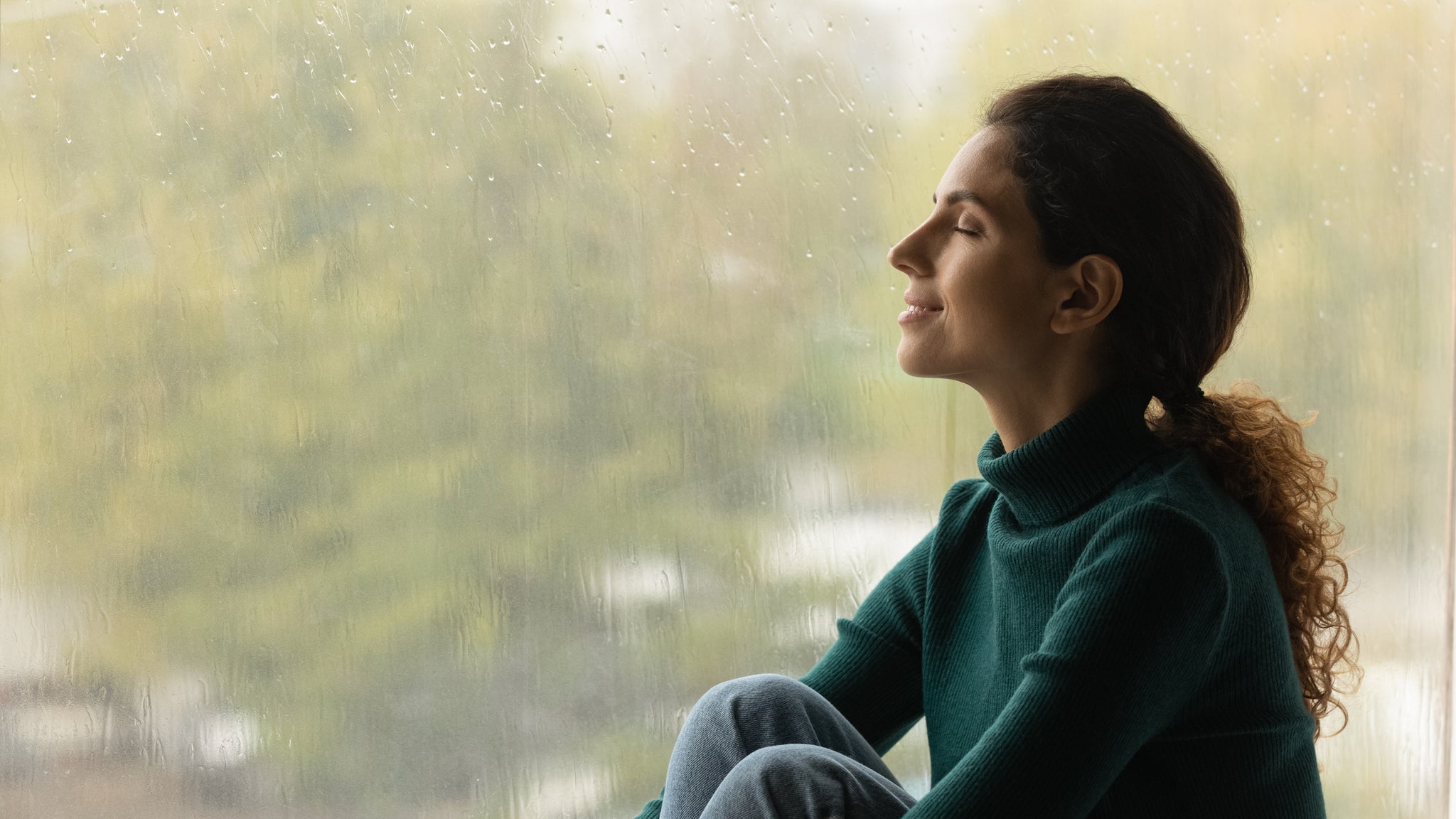 A woman smiles serenely.