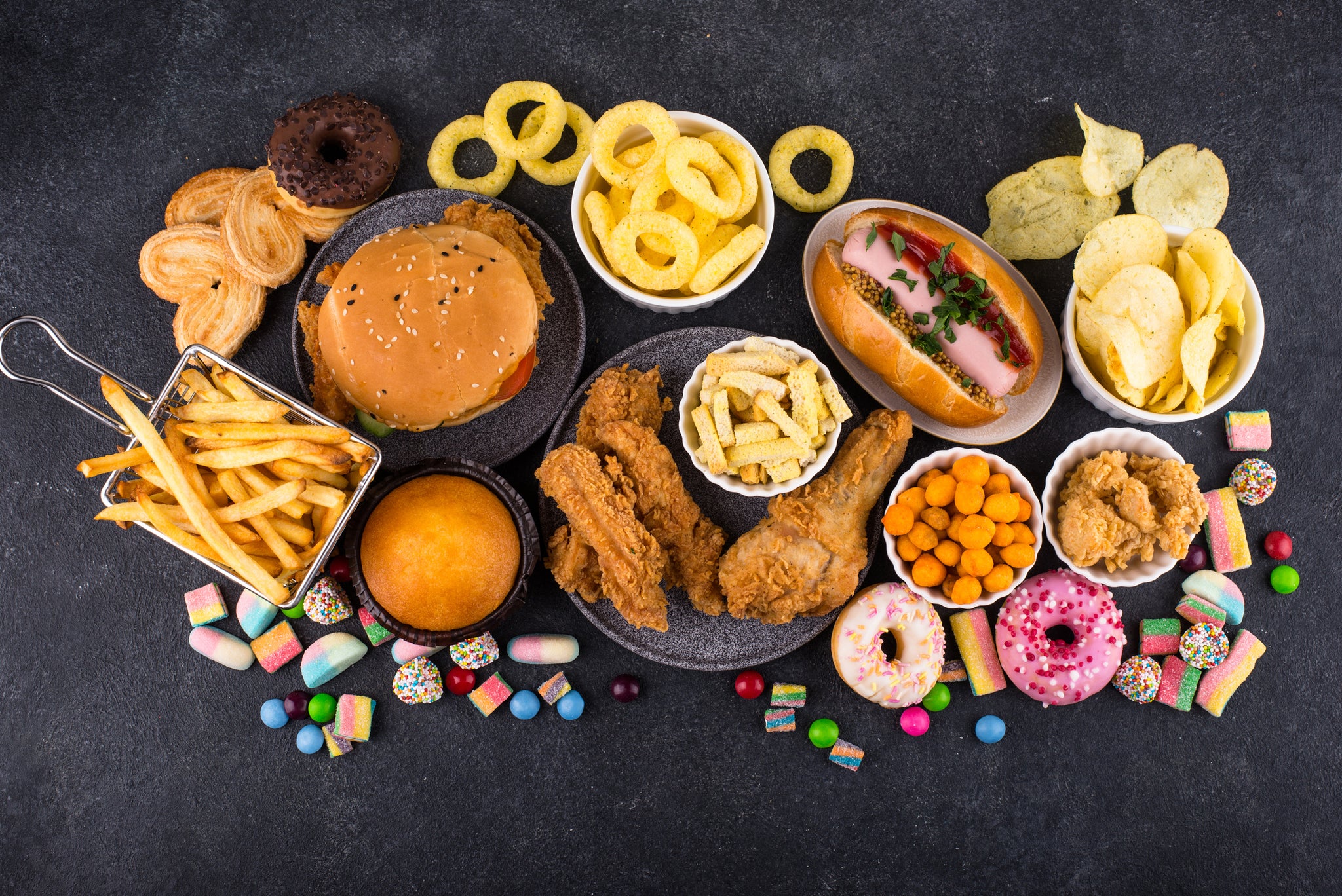 Assortment of unhealthy junk food. Burger, french fries, hot dog, snack and sweets