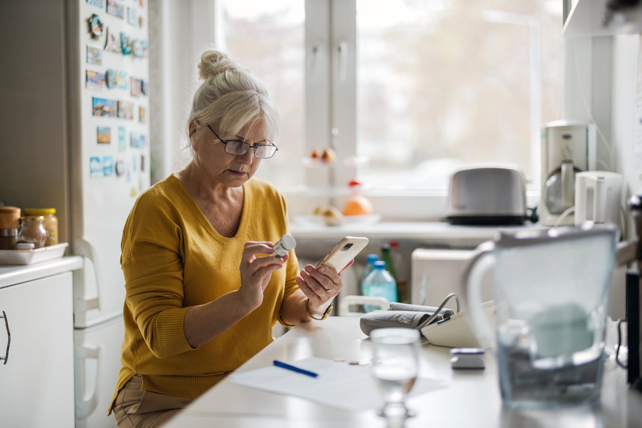 A woman reviews her prescription bottle.