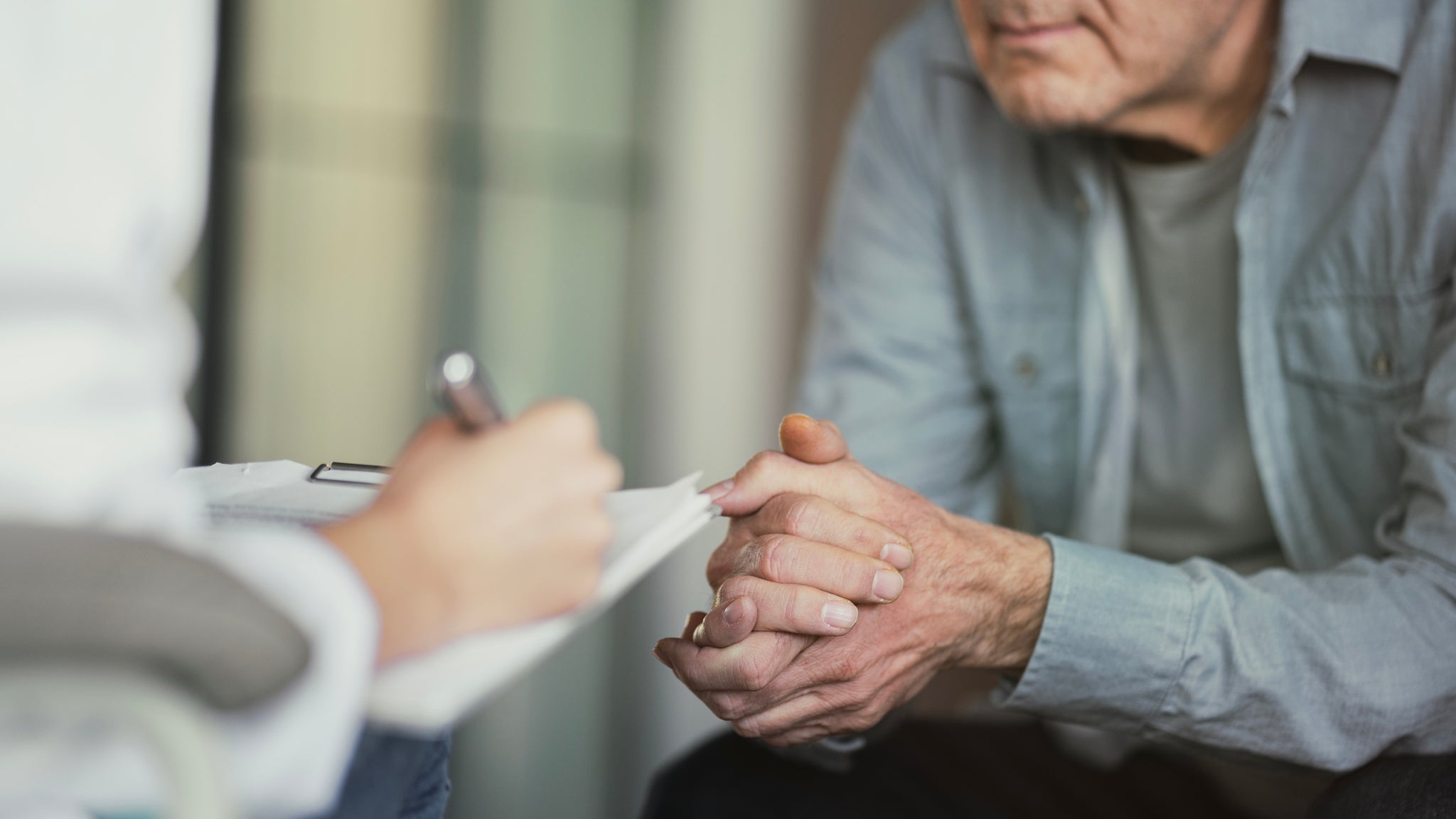 A man sits down with a doctor.