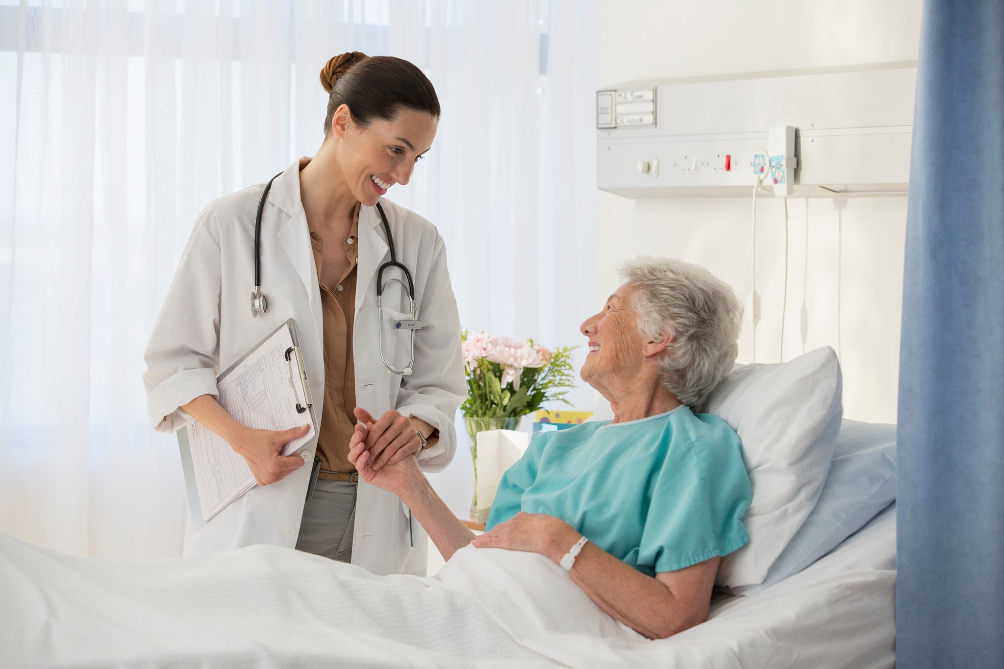 A doctor and a patient in a hospital room.