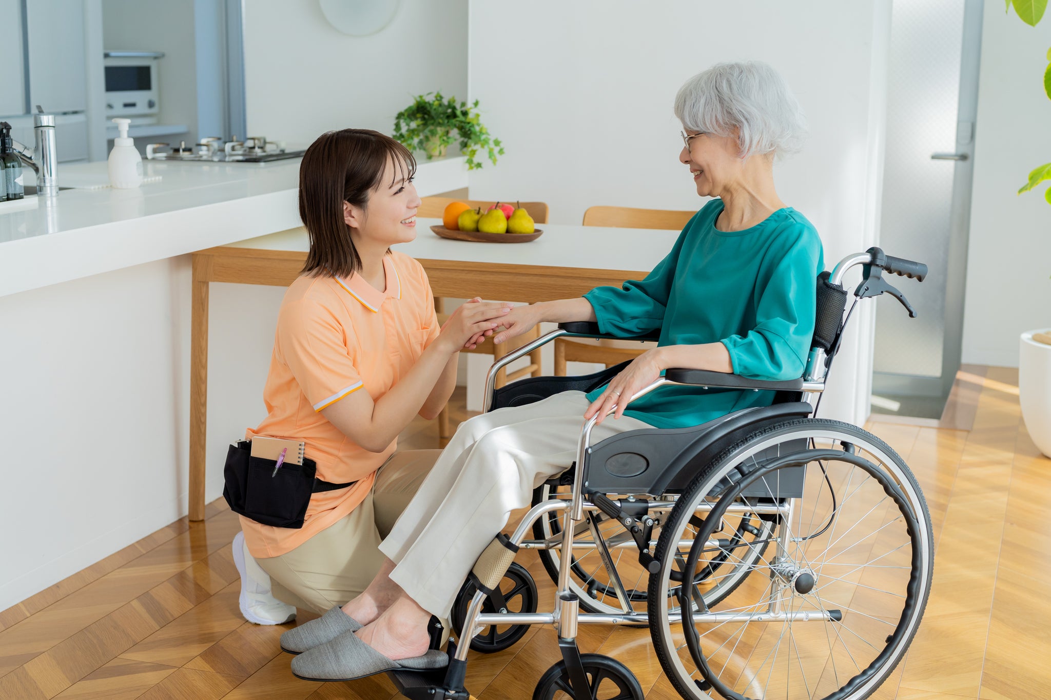 A caregiver smiles at her patient.