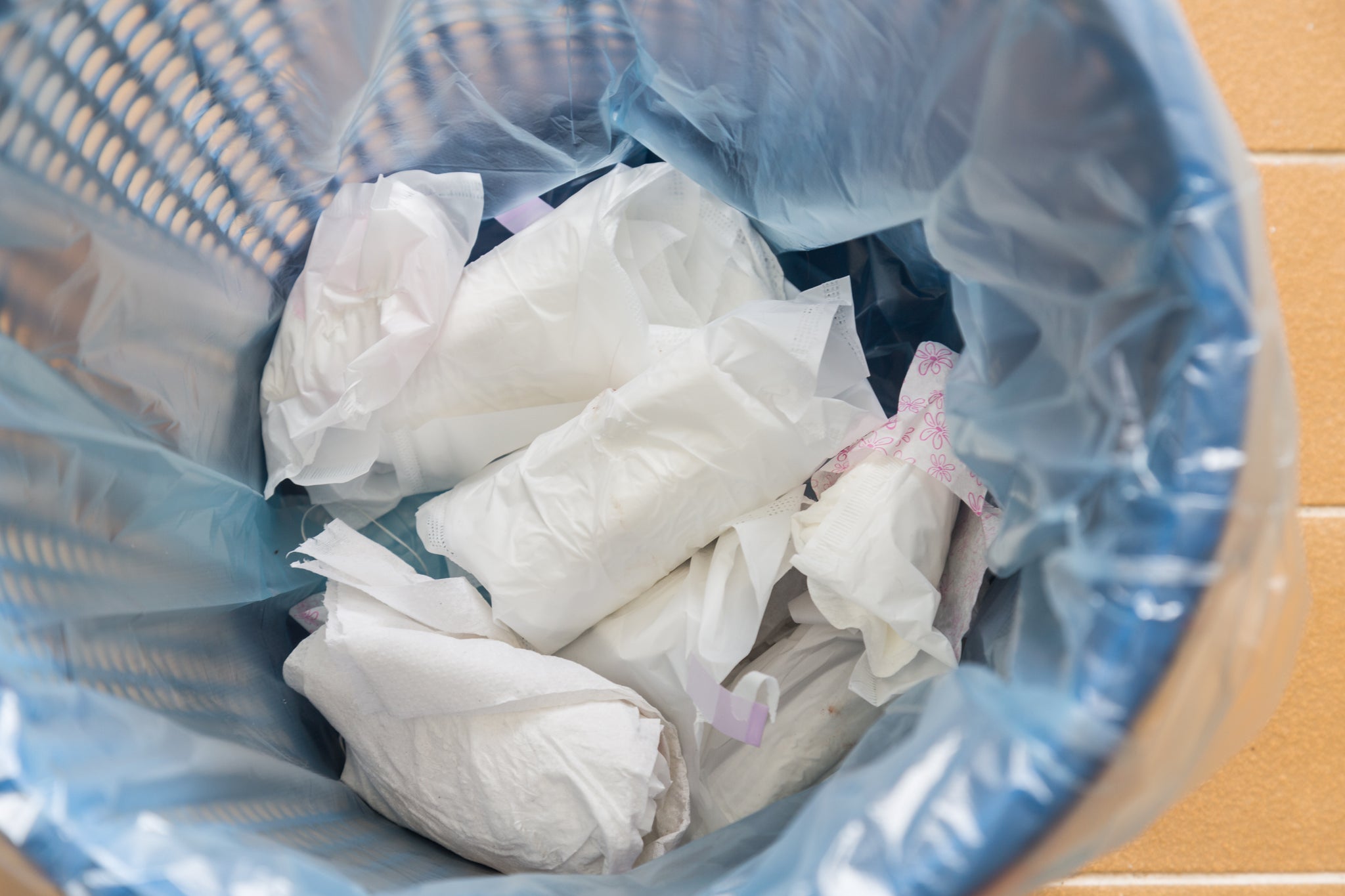 A close up of diapers in a trash can.