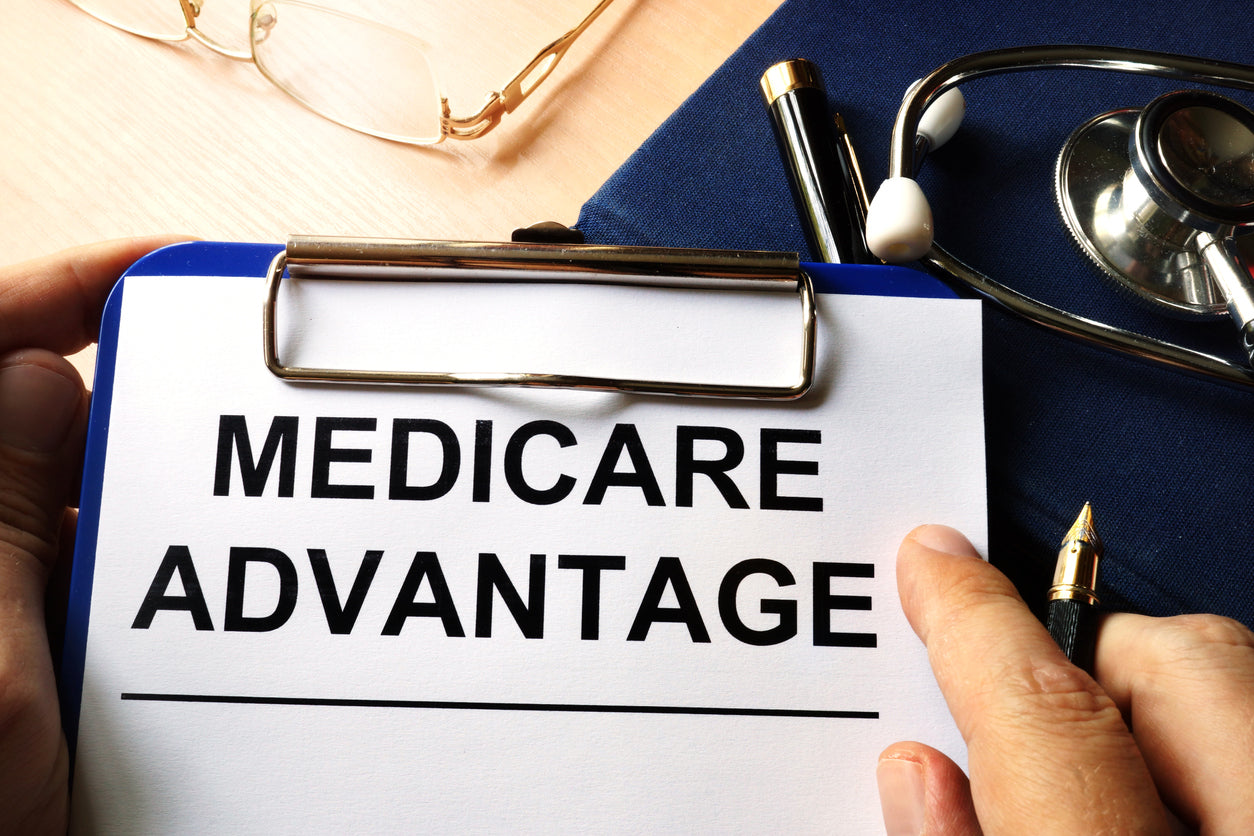 A clipboard with the words "Medicare Advantage" printed on a piece of paper.