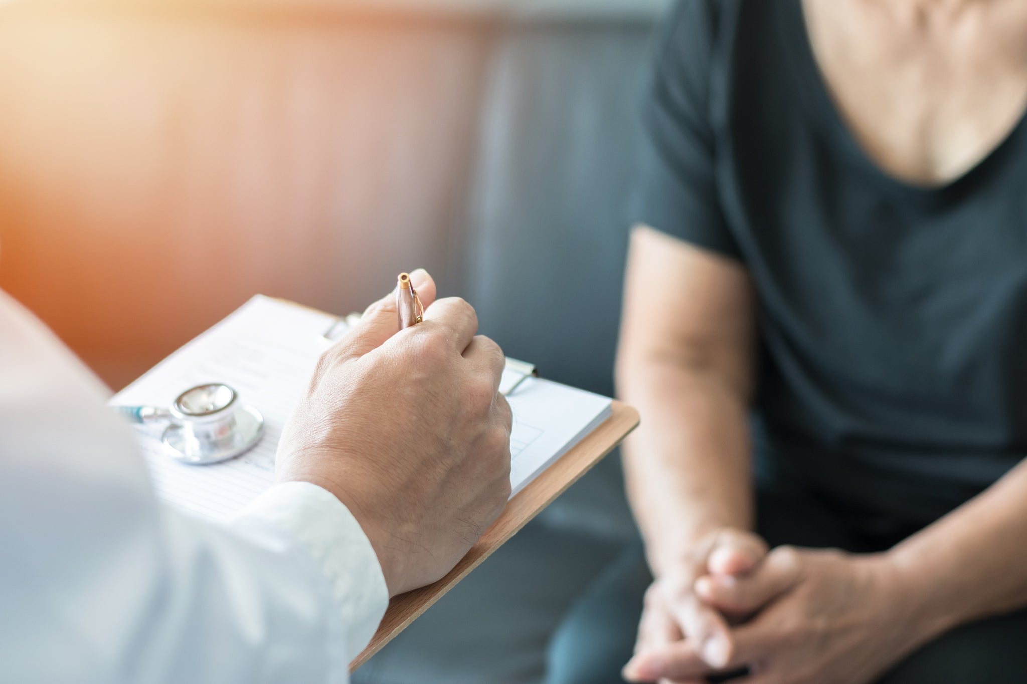 A patient goes over a medical chart with a doctor.