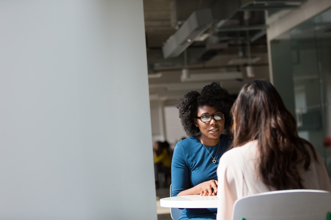 Two women have a private business meeting.