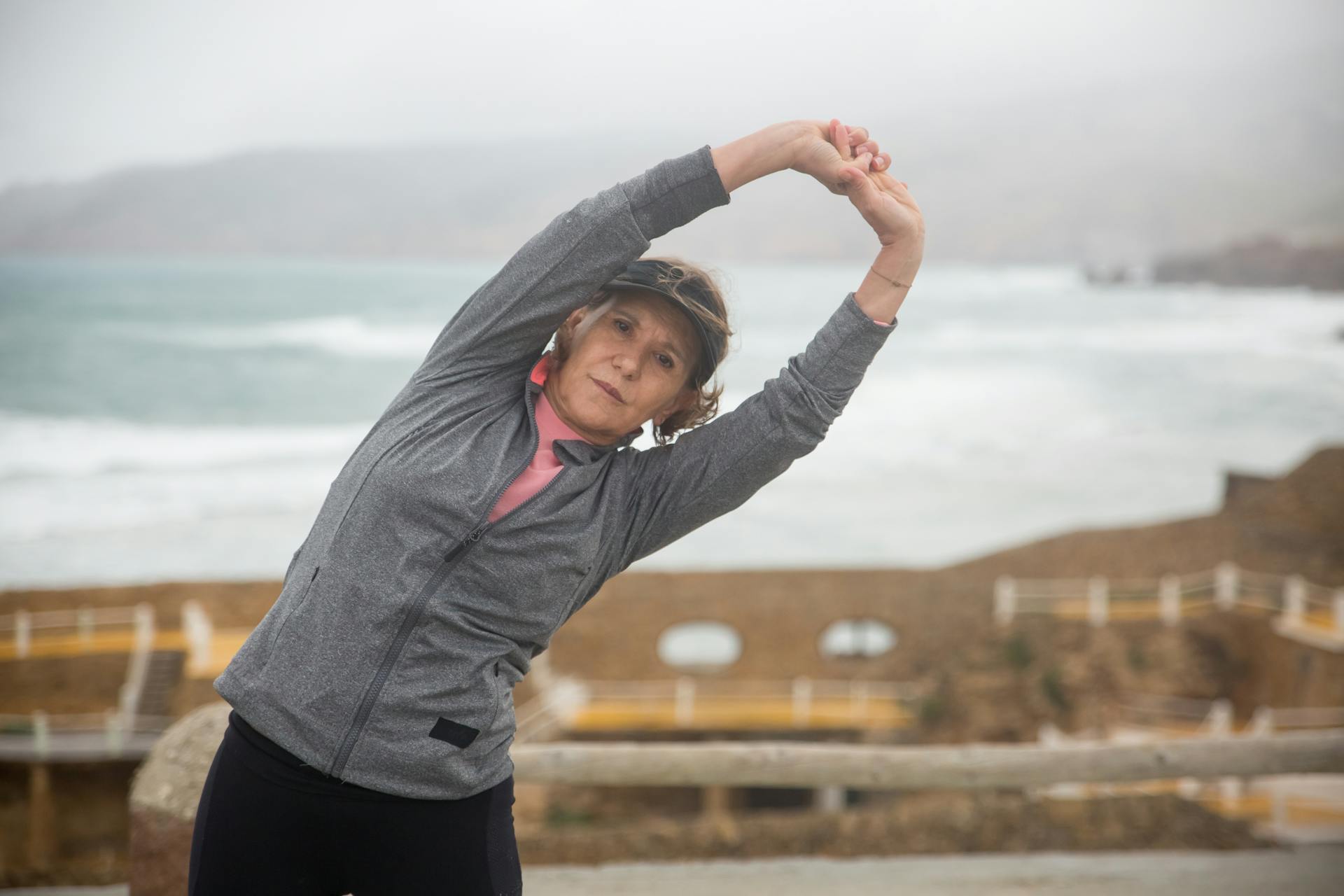 An older woman stretches before a run.